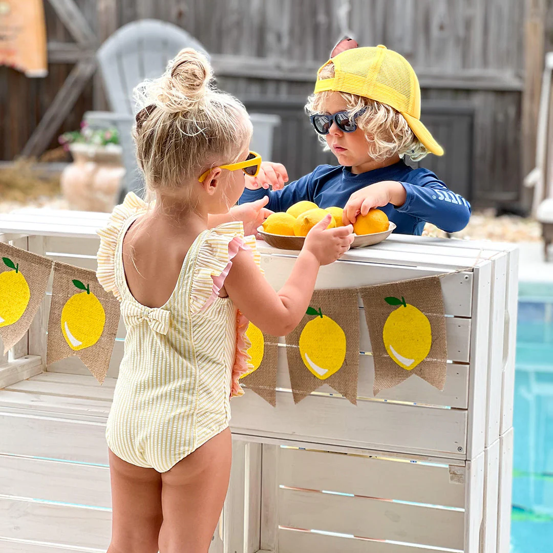 RuffleButts Toddler Seersucker One Piece with Roshambo Yellow Sunglasses - Image 4
